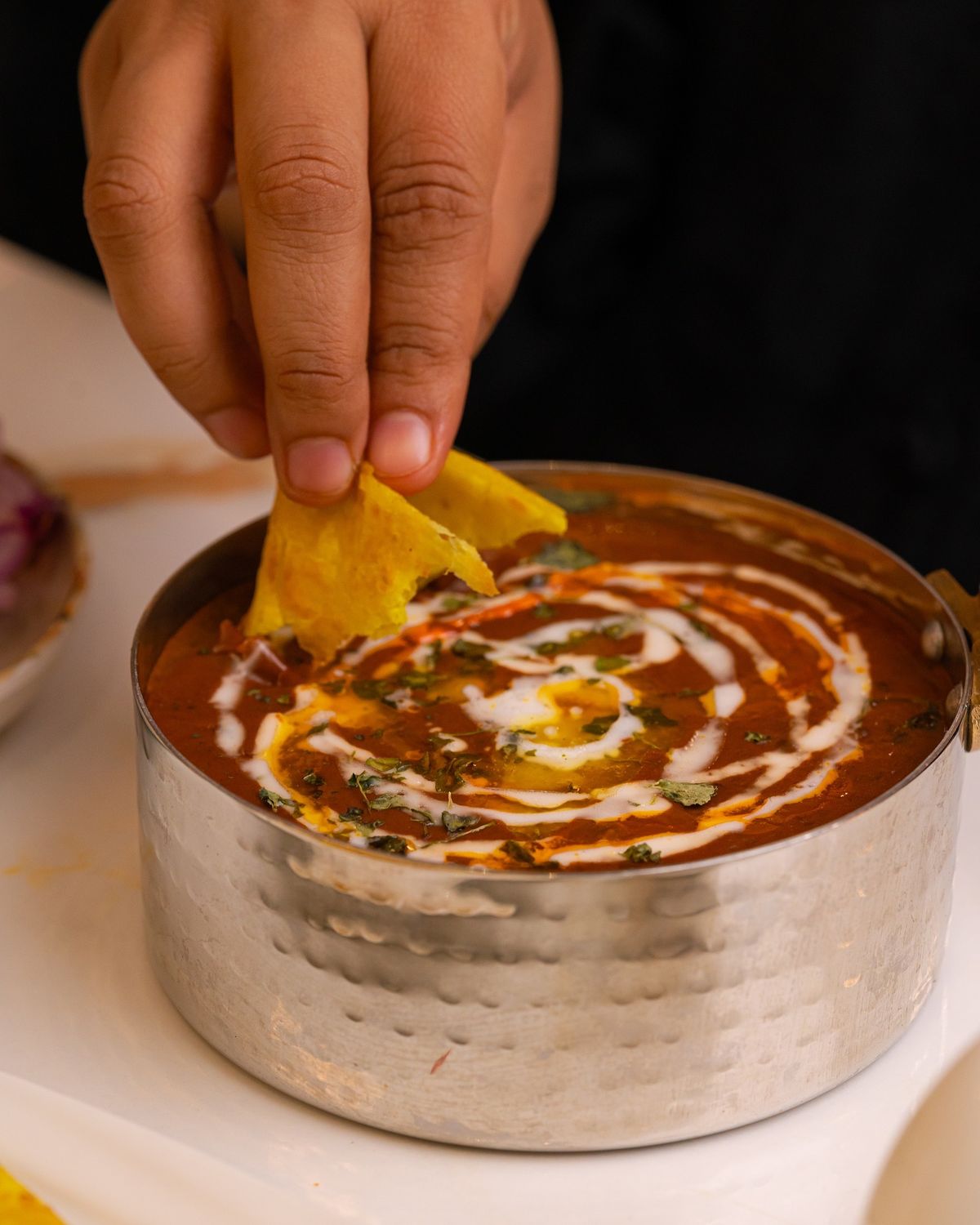 Dahi vada topped with tamarind chutney